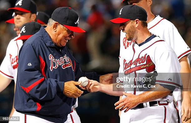 Reliever Billy Wagner of the Atlanta Braves hands the game ball over to manager Bobby Cox after their 3-2 win over the Chicago Cubs at Turner Field...