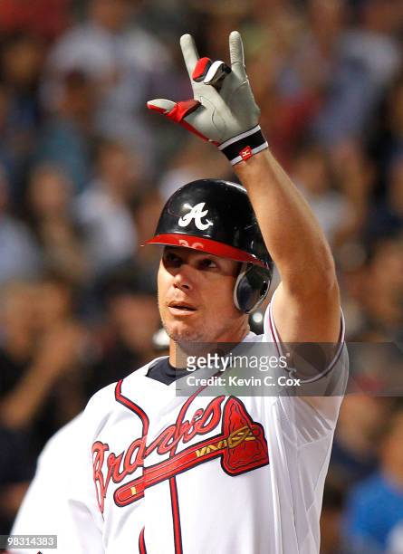 Chipper Jones of the Atlanta Braves celebrates after hitting a two-run homer in the bottom of the eighth inning to give the Braves a 3-2 lead over...