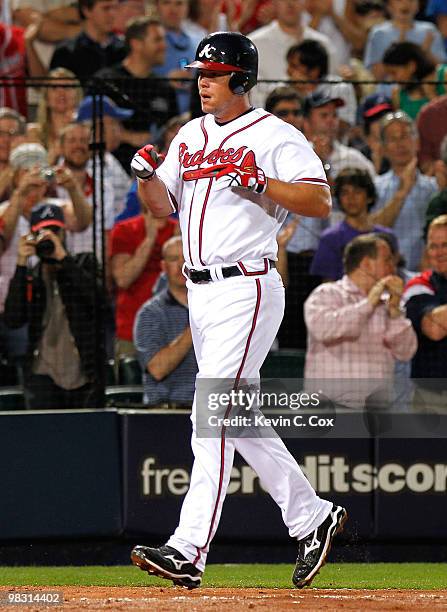 Chipper Jones of the Atlanta Braves celebrates after hitting a two-run homer in the bottom of the eighth inning to give the Braves a 3-2 lead over...