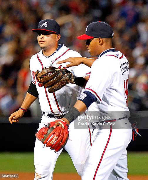 Martin Prado and Yunel Escobar of the Atlanta Braves celebrate an out at second base during the game against the Chicago Cubs at Turner Field on...