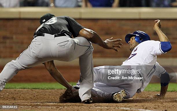 Fernando Tatis of the New York Mets is tagged out at home by pitcher Jose Veras of the Florida Marlins as he attempted to score in the seventh inning...