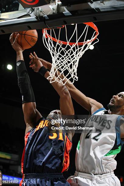 Chris Hunter of the Golden State Warriors goes up for a shot against Corey Brewer of the Minnesota Timberwolves during the game on April 7, 2010 at...