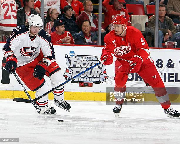 Jakub Voracek of the Columbus Blue Jackets tries to keep control of the puck away from Nicklas Lidstrom of the Detroit Red Wings during an NHL game...