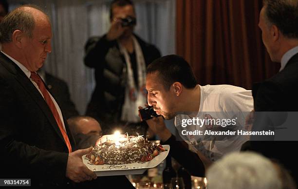 Uli Hoeness , President of Bayern Muenchen presents Franck Ribery a birthday cake for his 27 birthday during the Champions League dinner at the...