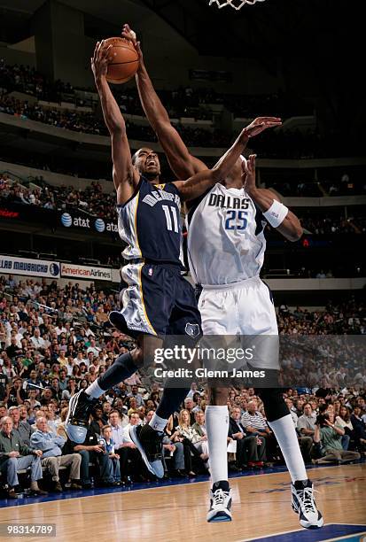 Mike Conley of the Memphis Grizzlies has his layup attempt blocked by Erick Dampier of the Dallas Mavericks during a game at the American Airlines...