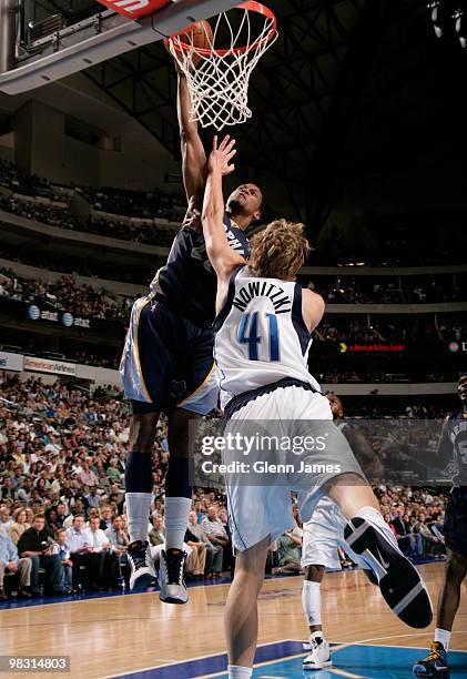 Rudy Gay of the Memphis Grizzlies goes up for the dunk against Dirk Nowitzki of the Dallas Mavericks during a game at the American Airlines Center on...