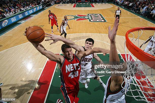 Ersan Ilyasova of the Milwaukee Bucks attempts to block a shot by Kris Humphries of the New Jersey Nets on April 7, 2010 at the Bradley Center in...