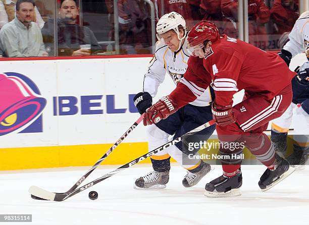 Martin Erat of the Nashville Predators and Zbynek Michalek of the Phoenix Coyotes struggle for control of the puck on April 7, 2010 at Jobing.com...