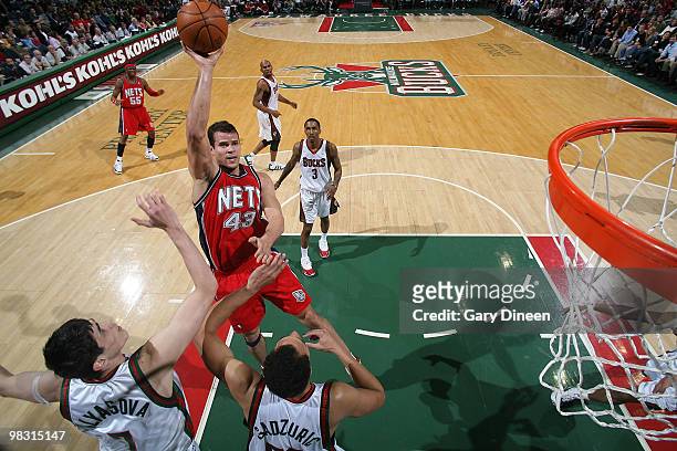 Kris Humphries of the New Jersey Nets shoots a floater against Ersan Ilyasova and Dan Gadzuric of the Milwaukee Bucks on April 7, 2010 at the Bradley...