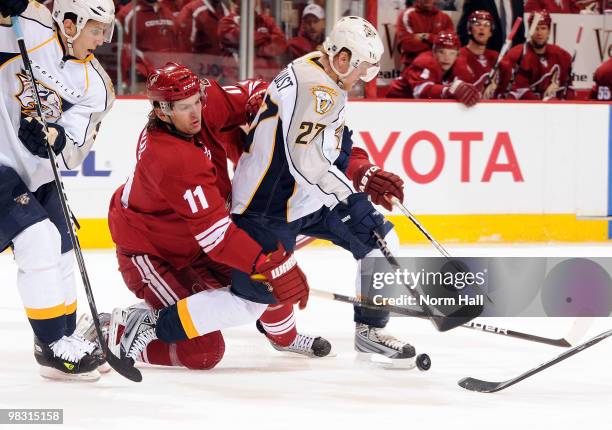 Martin Hanzal of the Phoenix Coyotes tries to take the puck away from Patric Hornqvist of the Nashville Predators on April 7, 2010 at Jobing.com...