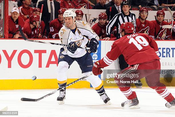 Shea Weber of the Nashville Predators passes the puck over the stick of a defending Shane Doan of the Phoenix Coyotes on April 7, 2010 at Jobing.com...