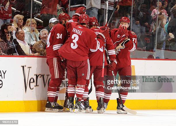 Keith Yandle and Daniel Winnik celebrate with teammates after a first period goal against the Nashville Predators on April 7, 2010 at Jobing.com...