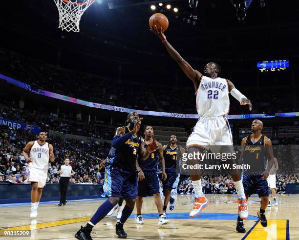 Jeff Green of the Oklahoma City Thunder goes up for a shot over Johan Petro of the Denver Nuggets during the game at the Ford Center on April 7, 2010...
