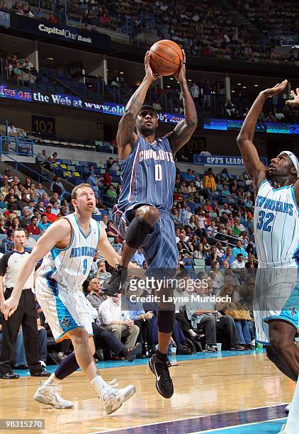 Larry Hughes of the Charlotte Bobcats shoots over Darius Songaila and Julian Wright of the New Orleans Hornets on April 7, 2010 at the New Orleans...