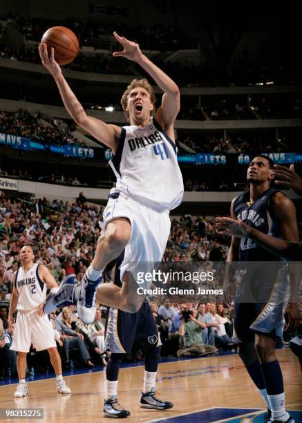 Dirk Nowitzki of the Dallas Mavericks goes in for the layup against Rudy Gay of the Memphis Grizzlies during a game at the American Airlines Center...