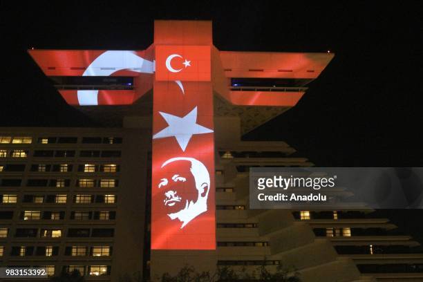 Turkish flags and a portrait of Turkish President Recep Tayyip Erdogan are projected on the facade of Sheraton Grand Doha Resort and Convention Hotel...