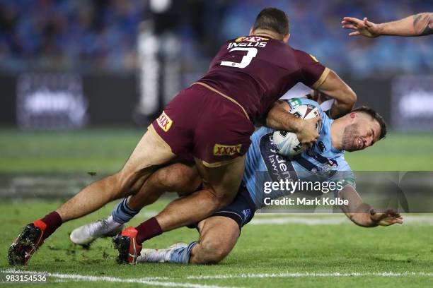 Greg Inglis of the Maroons tackles James Tedesco of the Blues during game two of the State of Origin series between the New South Wales Blues and the...