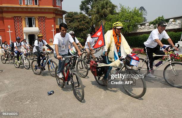 Lifestyle-Nepal-cycling-Everest" by Subel Bhandari Nepalese cyclist Pushkar Shah holds a Nepalese flag as he cycles with supporters in Kathmandu on...