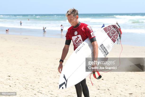 Kevin Schulz of USA exits the water after losing his semi final heat at the 2018 Shoe City Pro at the Huntington Beach Pier on June 24, 2018 in...