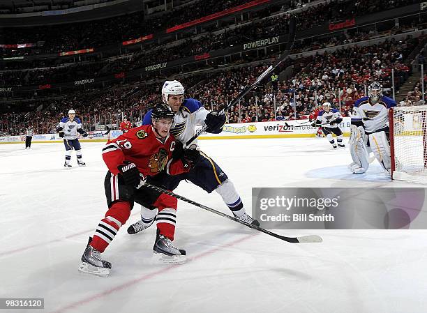 Jonathan Toews of the Chicago Blackhawks and Eric Brewer of the St. Louis Blues battle for position during the game on April 07, 2010 at the United...