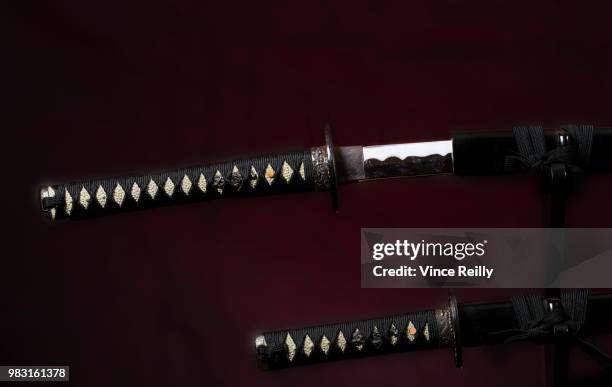 samurai katana  above the tanto slightly out of the scabbard - dagger isolated stock pictures, royalty-free photos & images