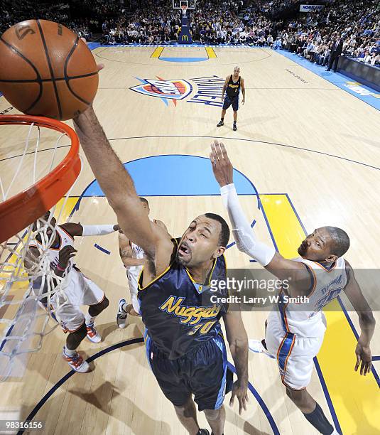 Malik Allen of the Denver Nuggets goes to the basket against Kevin Durant of the Oklahoma City Thunder during the game at the Ford Center on April 7,...