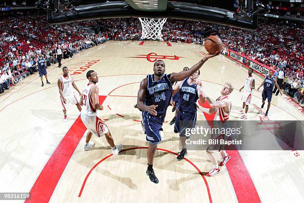 Paul Millsap of the Utah Jazz shoots the ball over Chase Budinger of the Houston Rockets on April 7, 2010 at the Toyota Center in Houston, Texas....