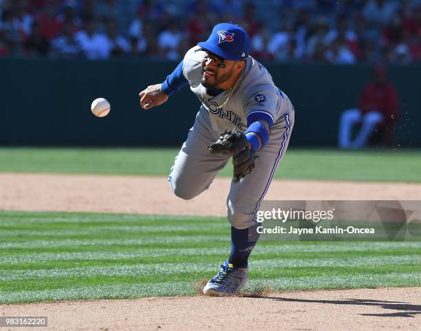 Devon Travis of the Toronto Blue Jays tosses the ball to first but unable to get Justin Upton of the Los Angeles Angels of Anaheim out in the tenth...