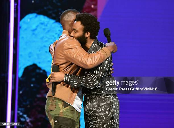 Host Jamie Foxx and Donald Glover embrace onstage at the 2018 BET Awards at Microsoft Theater on June 24, 2018 in Los Angeles, California.