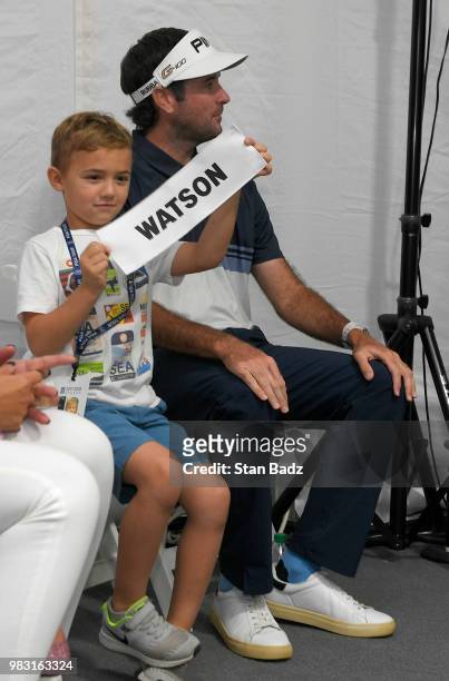 Caleb Watson, son of Bubba Watson holds his father's nameplate after final round of the Travelers Championship at TPC River Highlands on June 24,...