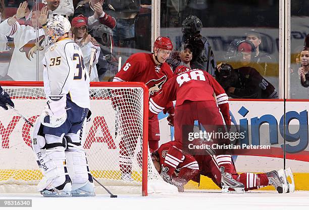 Matthew Lombardi and Wojtek Wolski of the Phoenix Coyotes celebrate with teammate Shane Doan after Doan scored a third period goal past goaltender...