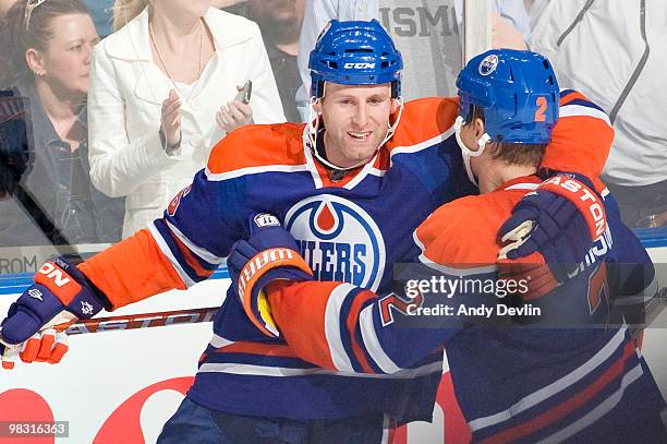 Aaron Johnson and Ryan Whitney celebrate the overtime winning goal against the Colorado Avalanche at Rexall Place on April 7, 2010 in Edmonton,...