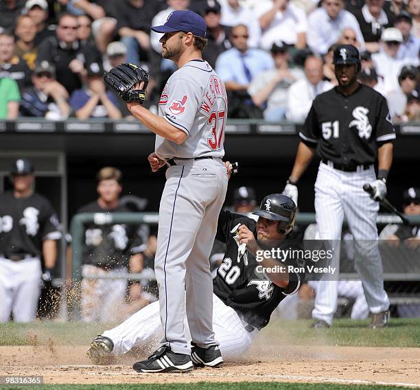 Carlos Quentin of the Chicago White Sox slides home safely as Jake Westbrook of the Cleveland Indians waits for the throw during the game on April 5,...