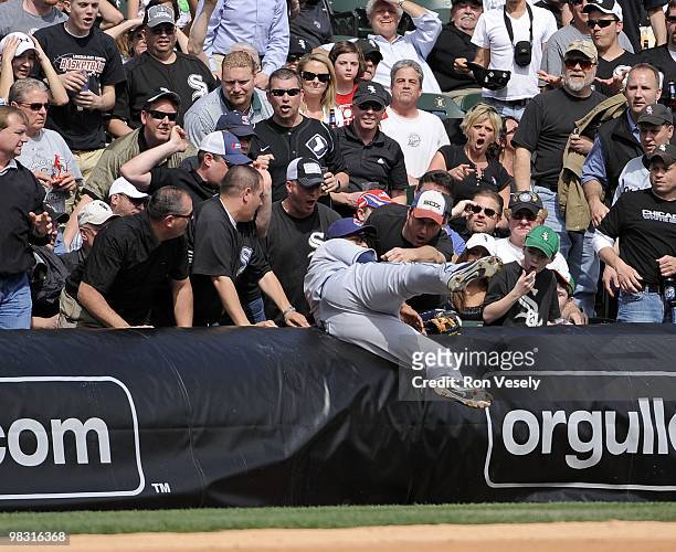 Jhonny Peralta of the Cleveland Indians falls into the stands to make a catch against the Chicago White Sox on April 5, 2010 at U.S. Cellular Field...