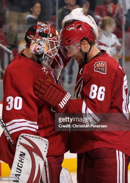 Goaltender Ilya Bryzgalov of the Phoenix Coyotes is congratulated by teammate Wojtek Wolski after defeating the Nashville Predators in the NHL game...
