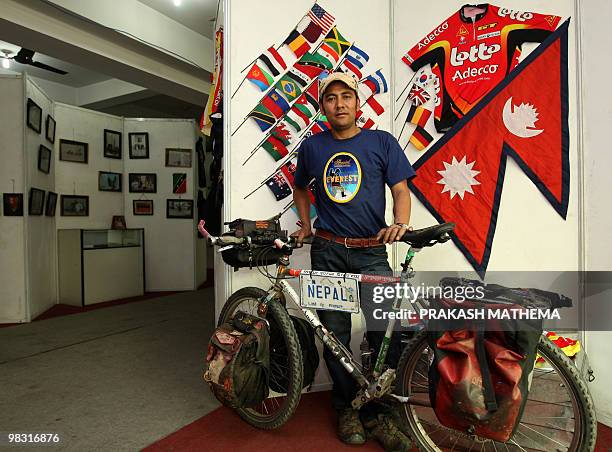 Lifestyle-Nepal-cycling-Everest,FEATURE by Subel Bhandari Nepalese cyclist Pushkar Shah poses with his bicycle in front of a display of the Nepalese...