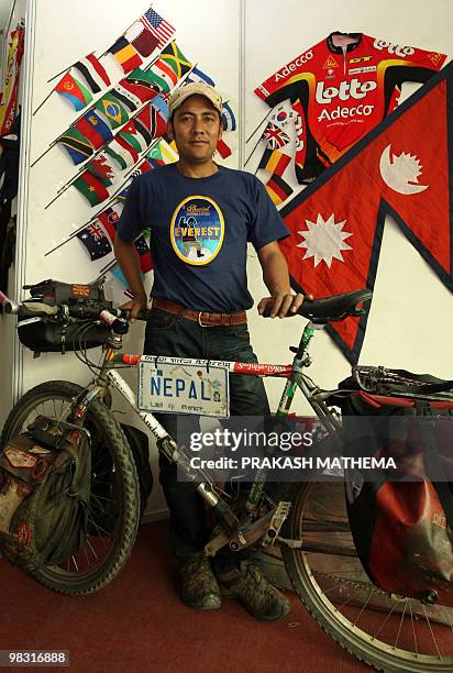 Lifestyle-Nepal-cycling-Everest,FEATURE by Subel Bhandari Nepalese cyclist Pushkar Shah poses with his bicycle in front of a display of the Nepalese...