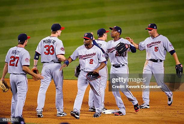 Hardy, Justin Morneau, Denard Span, Nick Punto, Delmon Young and Michael Cuddyer of the Minnesota Twins celebrate after defeating Los Angeles Angels...