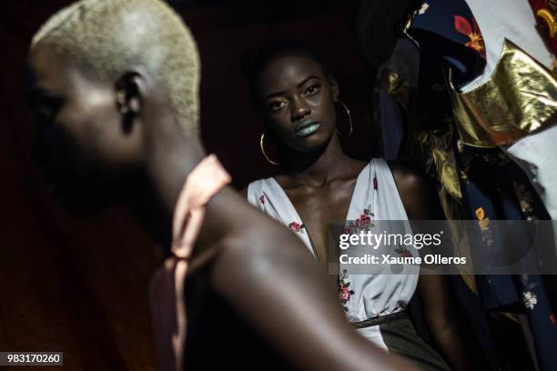 Models get ready ahead of the final day of the Dakar Fashion Week at the working class suburb of Keur Massar on June 24, 2018 in Dakar, Senegal.