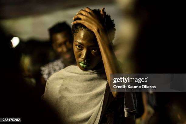 Models get ready ahead of the final day of the Dakar Fashion Week at the working class suburb of Keur Massar on June 24, 2018 in Dakar, Senegal.