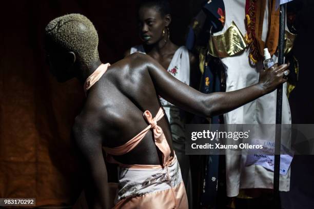 Models get ready ahead of the final day of the Dakar Fashion Week at the working class suburb of Keur Massar on June 24, 2018 in Dakar, Senegal.