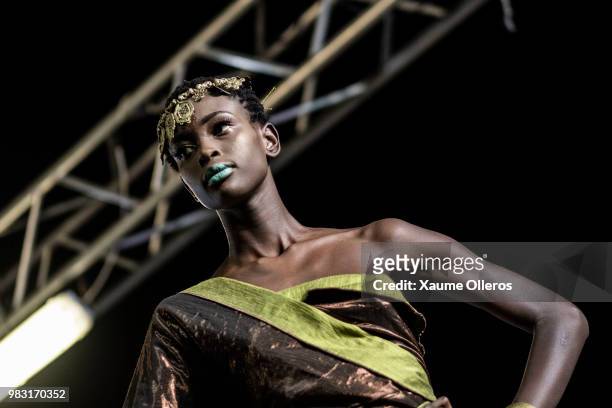 Model walks the runway during Ousmou Sy show on last day of the Dakar Fashion Week at the working class suburb of Keur Massar on June 24, 2018 in...