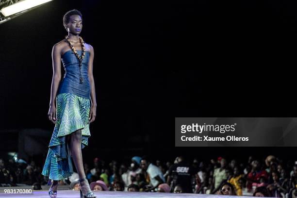 Model walks the runway during Mora show on last day of the Dakar Fashion Week at the working class suburb of Keur Massar on June 24, 2018 in Dakar,...