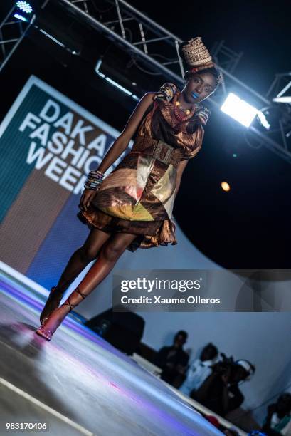 Model walks the runway during Ousmou Sy show on last day of the Dakar Fashion Week at the working class suburb of Keur Massar on June 24, 2018 in...