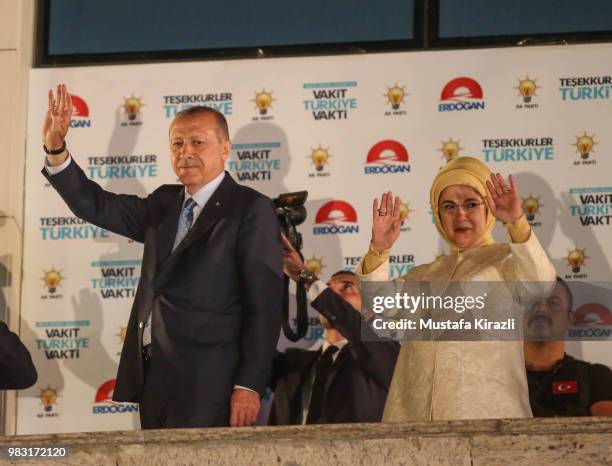 Turkey's President Recep Tayyip Erdogan and his wife Emine Erdogan greet supporters gathered in front of the AK Party headquarters on June 25, 2018...