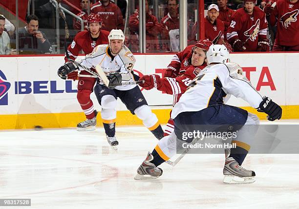 Matthew Lombardi of the Phoenix Coyotes fires a shot through traffic against the Nashville Predators on April 7, 2010 at Jobing.com Arena in...