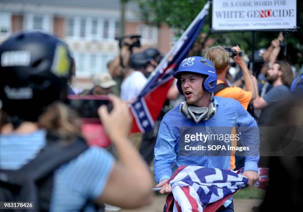 Man is seen shouting with a flag in his hands during the State of Emergency. White supremacists gathered at Emancipation Park in Charlottesville,...