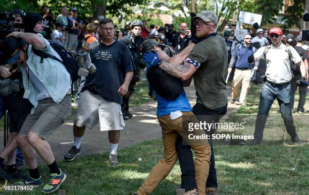 Member of the white supremacist and a protester are seen fighting. White supremacists gathered at Emancipation Park in Charlottesville, Virginia for...