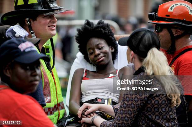 Young woman is surrounded by the rescue team, she appears to be injured. White supremacists gathered at Emancipation Park in Charlottesville,...