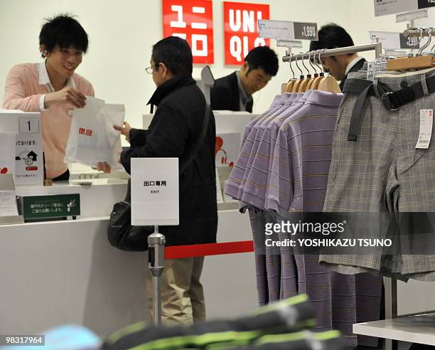 Shoppers purchase items in a Uniqlo store in Tokyo on April 8, 2010. The operator of Japan's recession-busting clothing chain Uniqlo said its interim...